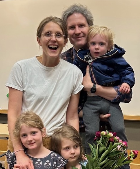Dr. Giuliana smiling big with her husband and 3 children just after her dissertation defense.